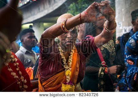 KUALA LUMPUR, MALAYSIA - FEBRUARY 3, 2015: Hindu devotees perform prayers at the Sri Mahamarriamman temple in Batu Caves. Hundreds of thousands of Hindu devotees come here for the Thaipusam prayers.