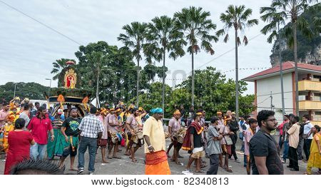 KUALA LUMPUR, MALAYSIA - FEBRUARY 3, 2015: Hindu devotees carry milk pots and kavadis walk in a procession to the Batu Caves temple on Thaipusam day, a day of thanksgiving and devotion.