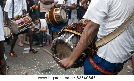 KUALA LUMPUR, MALAYSIA - FEBRUARY 3, 2015: Urumi melam drummers accompany devotees walk in a procession to the Batu Caves temple on Thaipusam day, a day of thanksgiving and devotion.