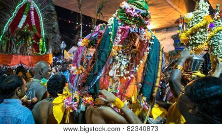 KUALA LUMPUR, MALAYSIA - FEBRUARY 3, 2015: Hindu devotees carry milk pots and kavadis walk in a procession to the Batu Caves temple on Thaipusam day, a day of thanksgiving and devotion.
