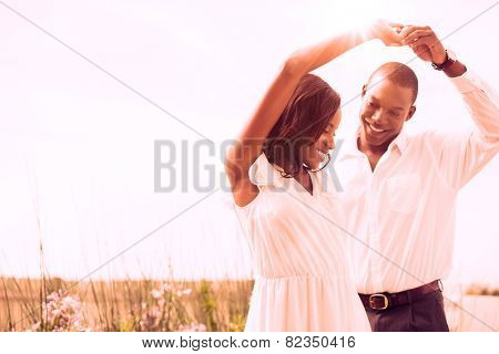 Romantic couple dancing and smiling outside in the garden