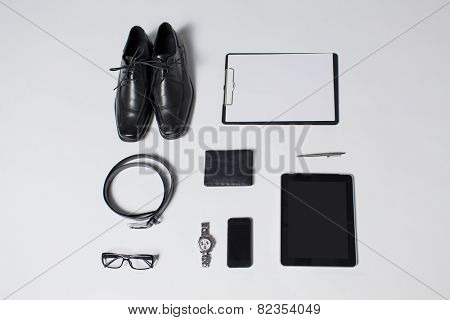 business, style, clothes and objects concept - close up of formal male clothes and personal stuff on table at home