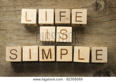 Life is Simple text on a wooden background