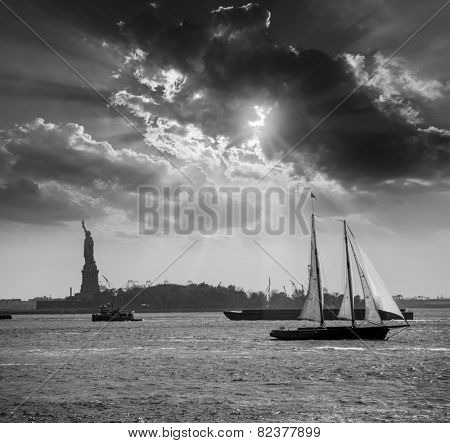 New York sailboat sunset and Statue of Liberty from Manhattan US