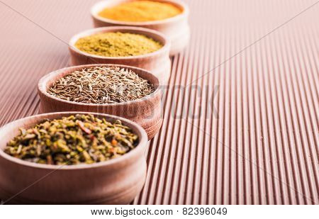 Cumin,turmeric,hops-suneli,paprika In A Wooden Bowl