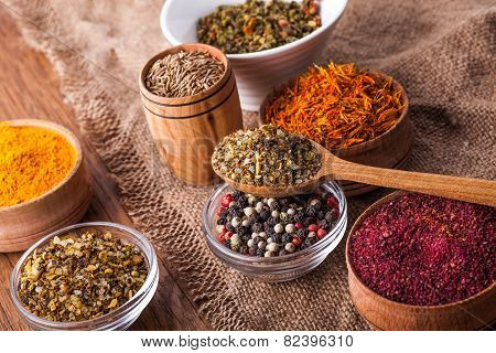 Dry Spices In A Wooden And Glass Bowls