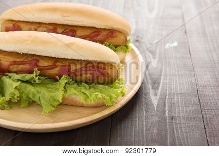Hot Dog With Ketchup On Wooden Background.