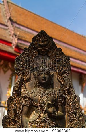 the ancient deva  statue with temple background