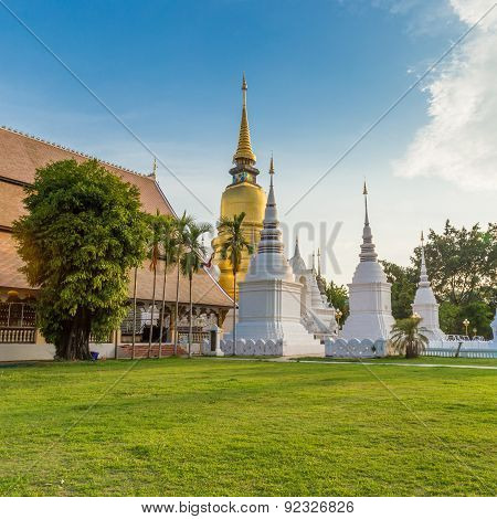 The Golden Pagoda At Wat Suan Dok, Chiang Mai, Thailand, With Beautiful Blue Sky.