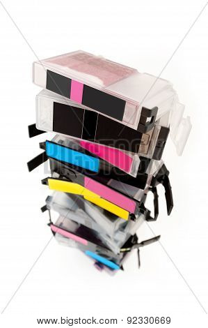 Empty ink cartridges stacked on white background