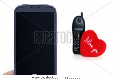 Blue smartphone and blurred telehone with heart. Idea for Valentines Day calls, love, lovers, love apps, Internet, blogs and others.