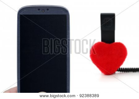 Blue smartphone and blurred telehone with heart. Idea for Valentines Day calls, love, lovers, love apps, Internet, blogs and others.