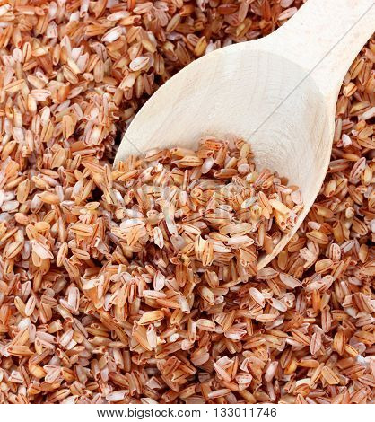 Red rice devzira in spoon close up