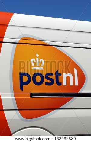 Almere Poort, Flevoland, The Netherlands - June 6, 2016: Orange PostNL logo on the side of a delivery van. Post.NL is the Dutch postal service.