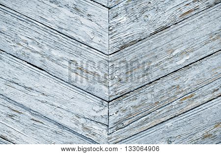 Wooden boards as a background. The texture of the fence. Vintage effect. Wooden planks blue diagonally. old peeling paint