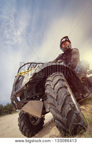Racing ATV on the sand in summertime.