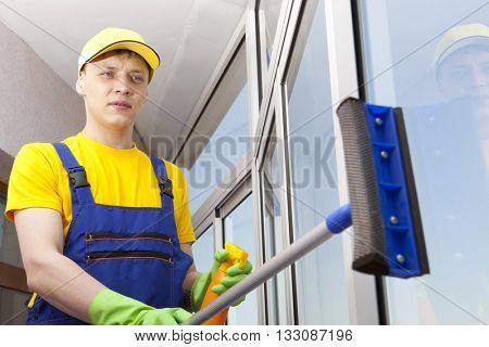 Professional cleaning, man washes window