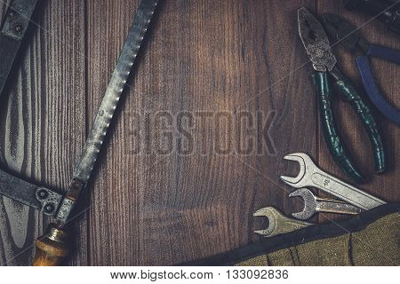 rusty construction instruments on the wooden background