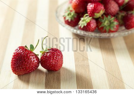 Fresh strawberry served on the wooden board