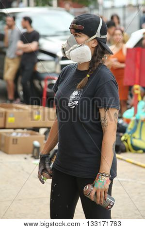 NEW YORK, - JUNE 4, 2016: Unidentified street artist in gas mask during Bushwick Collective Block Party in Brooklyn, New York