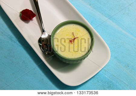 A bowl of Phirini an Indian dessert made of coarsely ground rice cooked in milk