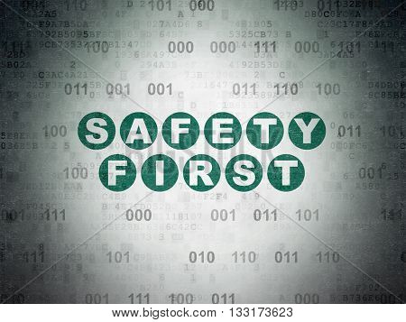 Safety concept: Painted green text Safety First on Digital Data Paper background with Binary Code