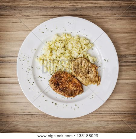 Tasty pork tenderlion with rice on the white plate. Food theme. International cuisine. Restaurant menu.