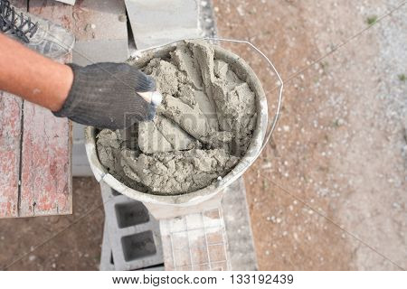 ready to use cement and old shovels at a construction site bucket.