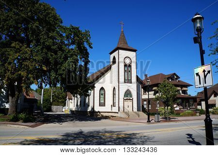 PLAINFIELD, ILLINOIS / UNITED STATES - SEPTEMBER 20, 2015: The former St Mary's Catholic Church, originally built as a Universalist church in 1836, now abandoned in downtown Plainfield.