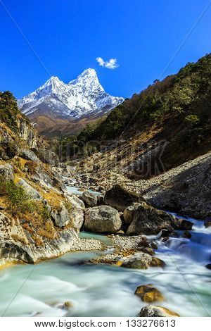 Beautiful alpine scenery in the Himalayas, with snow capped mountains and moraine glacier valley