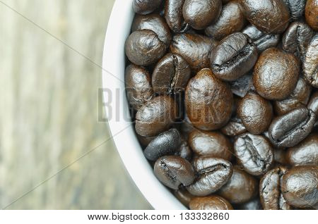 Close-up of coffee cup with coffee beans. View from top