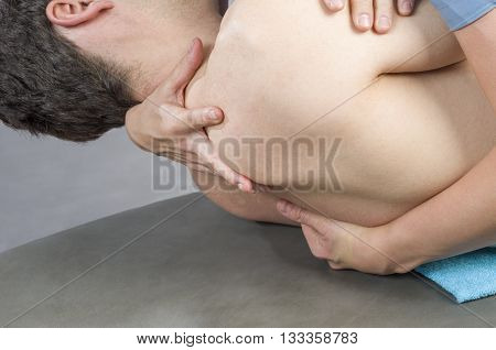 Physiotherapist Doing Manipulation To Man Patient. Osteopathy.