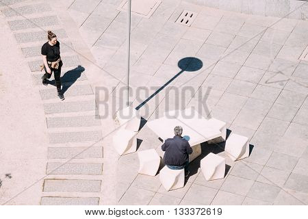 Tbilisi, Georgia - May 19, 2016: The waitress comes to the table at which a man is sitting. Street cafe in the park Rike