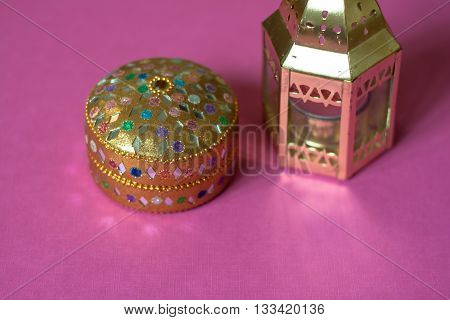 indian colorful box on pink table .