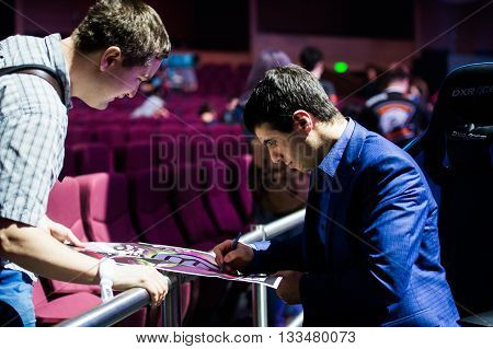 MOSCOW, RUSSIA - MAY 14 2016: EPICENTER MOSCOW Dota 2 cybersport event. Caster Commentator Versuta of the game giving the autograph
