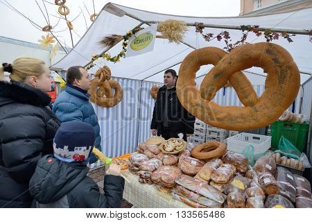 VILNIUS LITHUANIA - MARCH 7: Unidentified people trade home made bread in annual traditional crafts fair - Kaziuko fair on Mar 7 2015 in Vilnius Lithuania