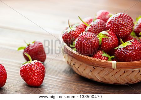 Very Beautiful Background With Fresh Strawberries In A Wicker Round Osier Basket On Old Brown Wooden
