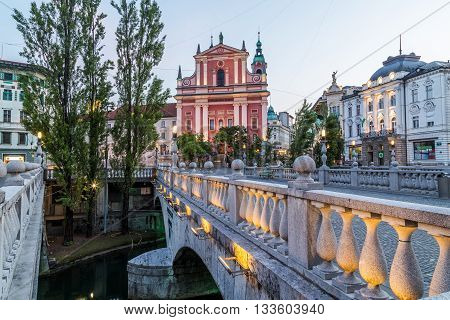 LJUBLJANA SLOVENIA - 27TH MAY 2016: The outside of Franciscan Church of the Annunciation Preseren Square and part of Triple Bridge in Ljubljana in the morning