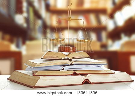 Justice scales on table in library