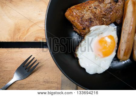 Homemade foods - Chicken fillet grilled steak and egg fried on wooden background