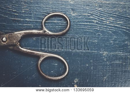old black scissors on the wooden background