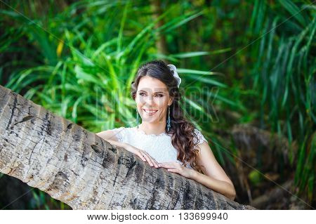 Close-up portrait young beautiful bride in a tropical jungle on a tropical island. Summer vacation concept.