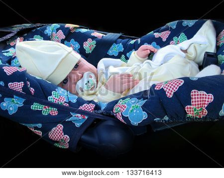 little beautiful baby in comfortable blu carseat