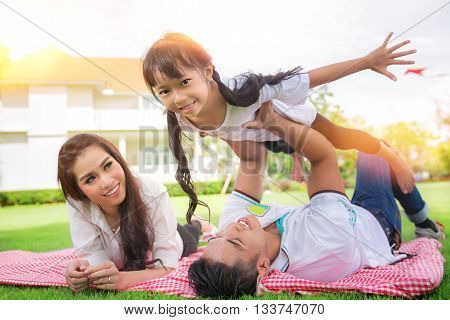 Beautiful family portrait smiling outside their new house picknic and outdoor concept