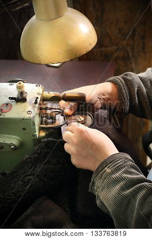 Furrier at the factory in the neck fur coat