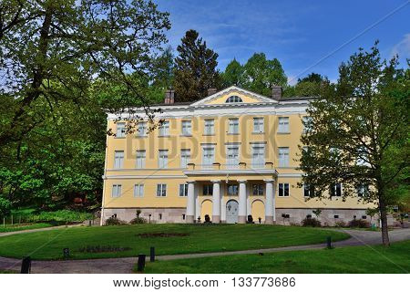 Old Fiskars manor in late spring. Mansion of a ancient steel mill complex.