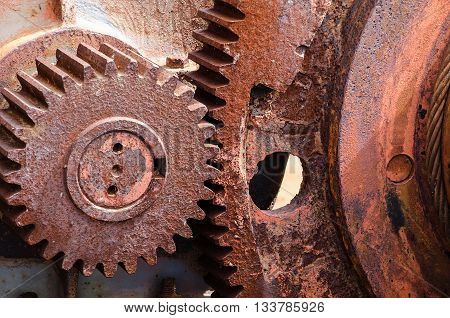 Rusty vintage cog wheel of the industrial winch. Close up.