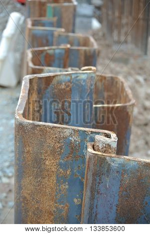 MALACCA, MALAYSIA -SEPTEMBER 25, 2015: Temporary steel sheet retaining wall using sheet pile cofferdam method holding outside soil from collapse into pile pits.