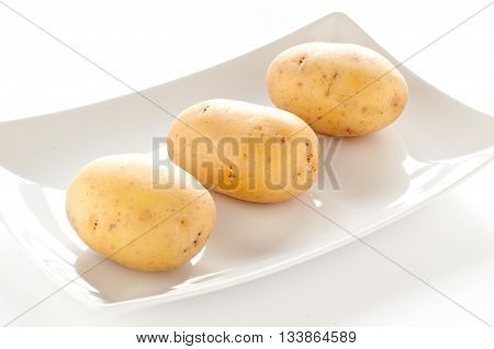 group of potatoes on white background italy