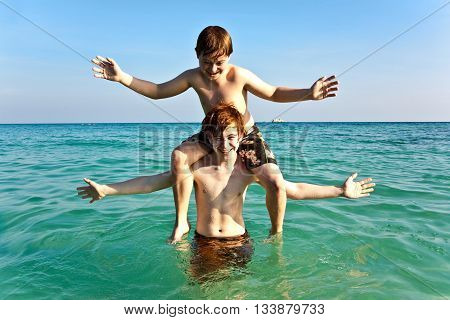 Brothers   Enjoy The Clear Warm Water And Play Pickaback